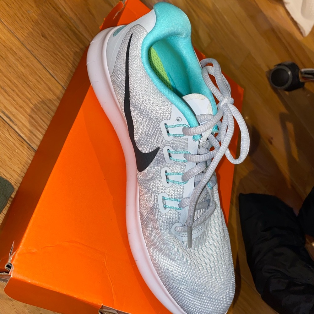 Mostly white Nike running sneakers.